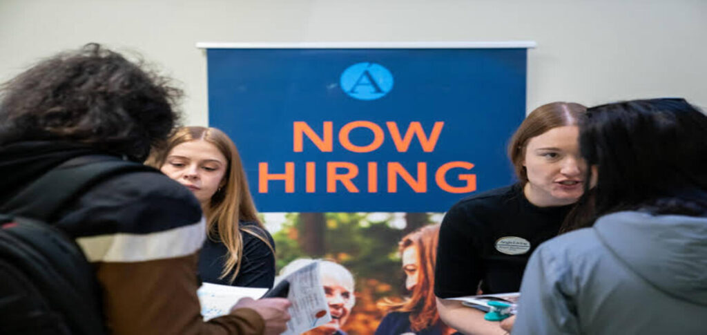 Workers in a U.S. financial district as employment unexpectedly declines in July while the unemployment rate remains at 4.1 percent.