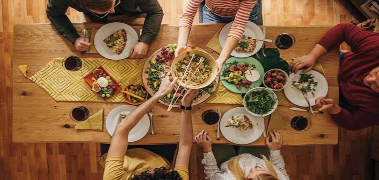 People eating together and enjoying a healthy shared meal