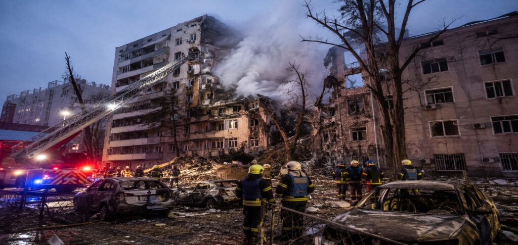 Emergency responders inspect damaged civilian buildings after a Russian missile attack in Kyiv