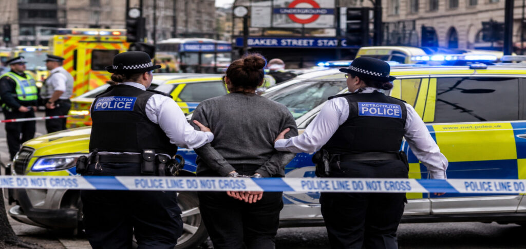 Metropolitan Police officers arrest a woman near an active crime scene in central London after a stabbing incident that injured four people.