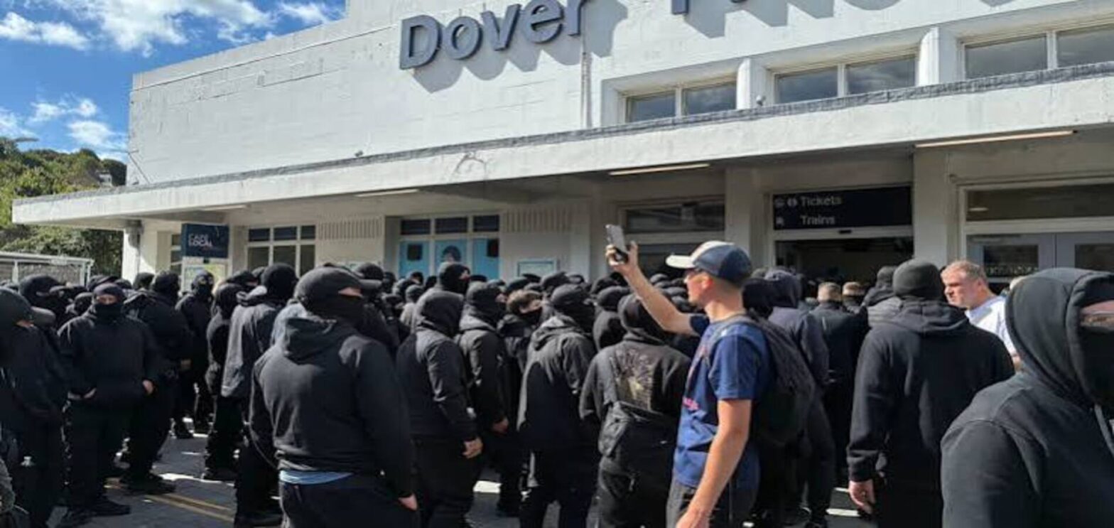 Masked protesters gather near Dover Port during ferry service disruption