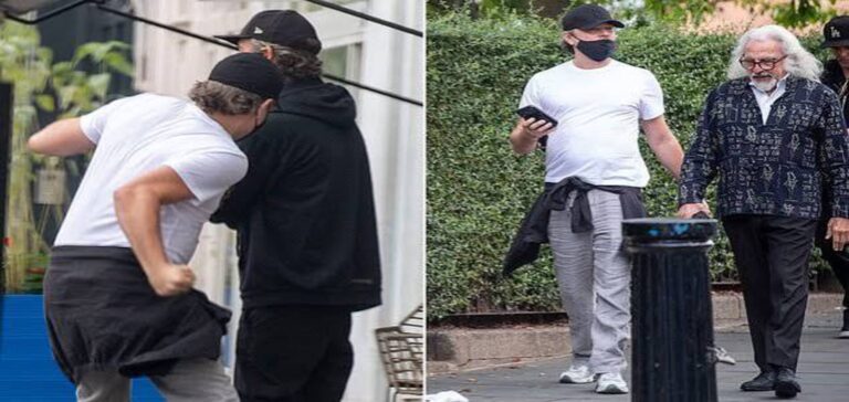 Leonardo DiCaprio play-fights with friend during London outing