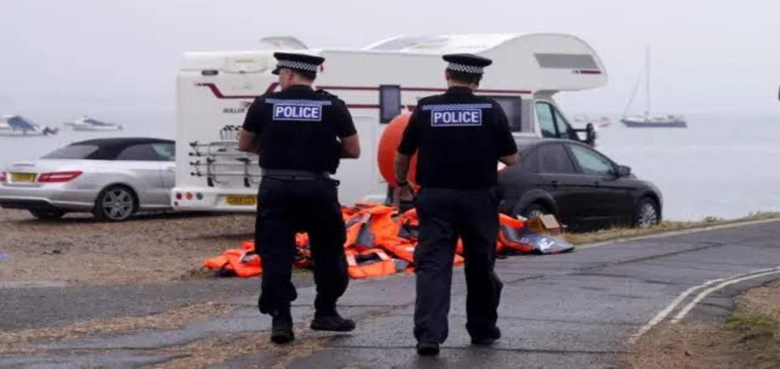 Police officers at a Portsmouth protest following the arrival of migrants by small boat