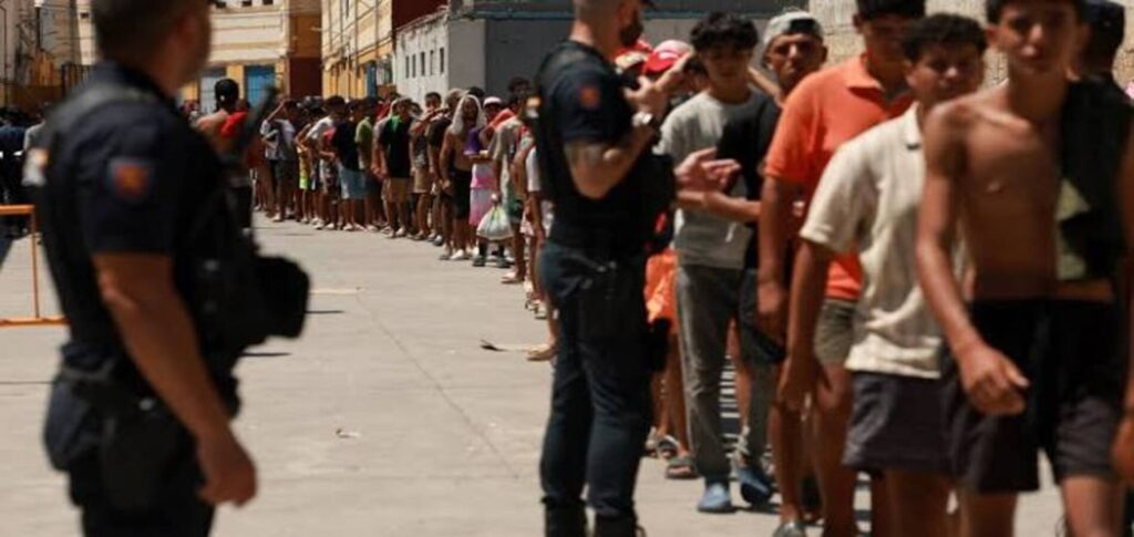 Travellers undergo passport checks at a Spanish airport amid extended border controls with Italy